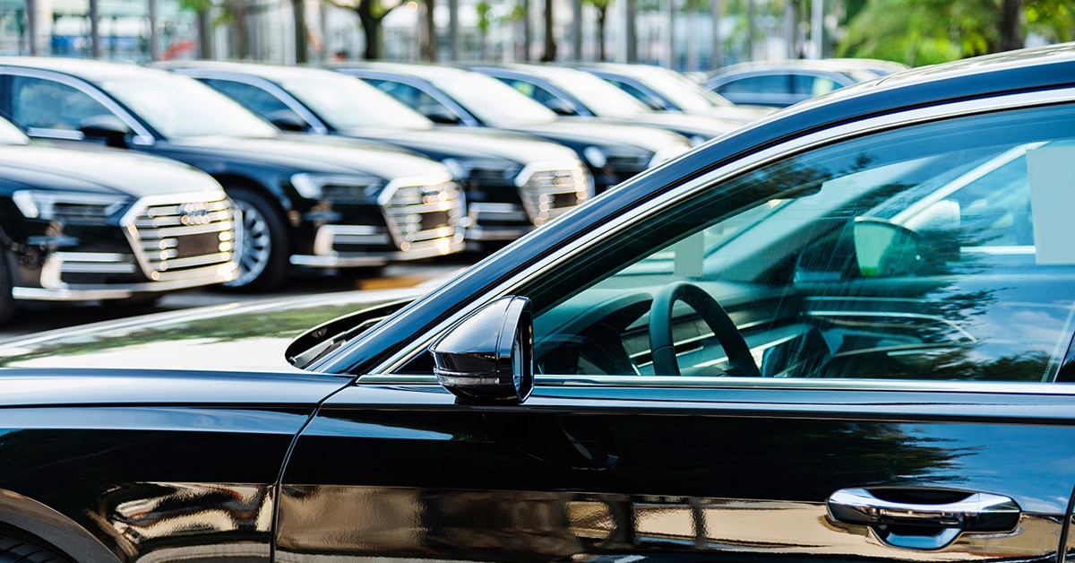 A parking lot full of black cars.